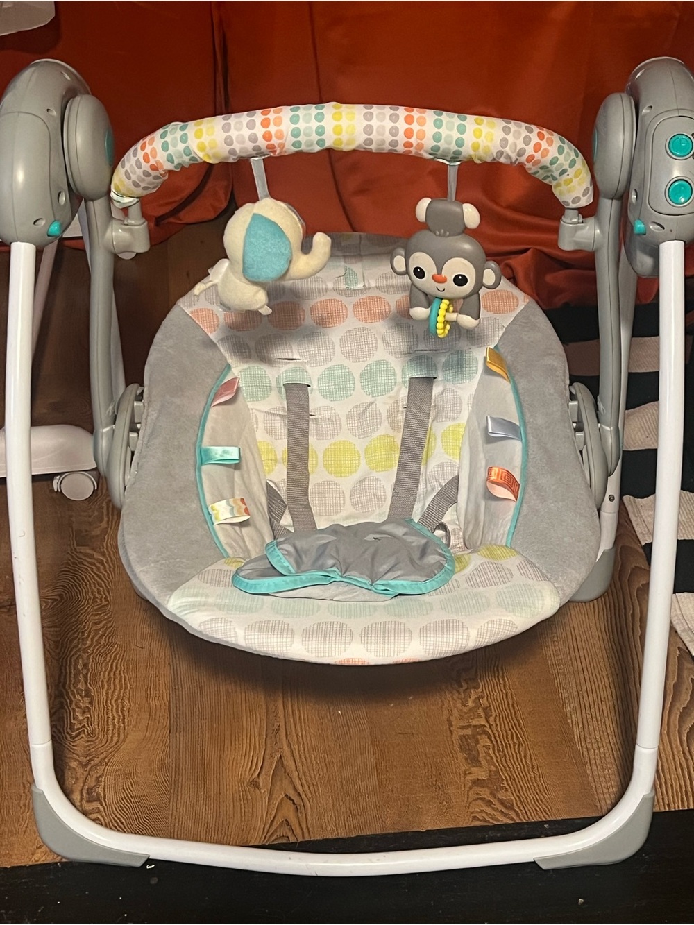 Gray Infant Swing with Colorful Polka Dot Accents